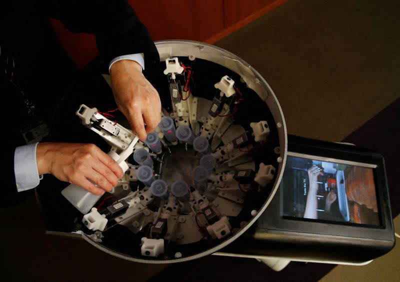 Demonstration of Taste the TV (TTTV), a prototype lickable TV screen that can imitate the flavours of various foods in Tokyo