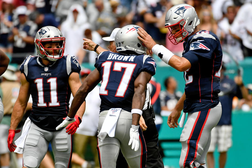 Sep 15, 2019; Miami Gardens, FL, USA; New England Patriots quarterback Tom Brady (12) congratulates wide receiver Antonio Brown (17) during the first half against the Miami Dolphins at Hard Rock Stadium. Mandatory Credit: Jasen Vinlove-USA TODAY Sports