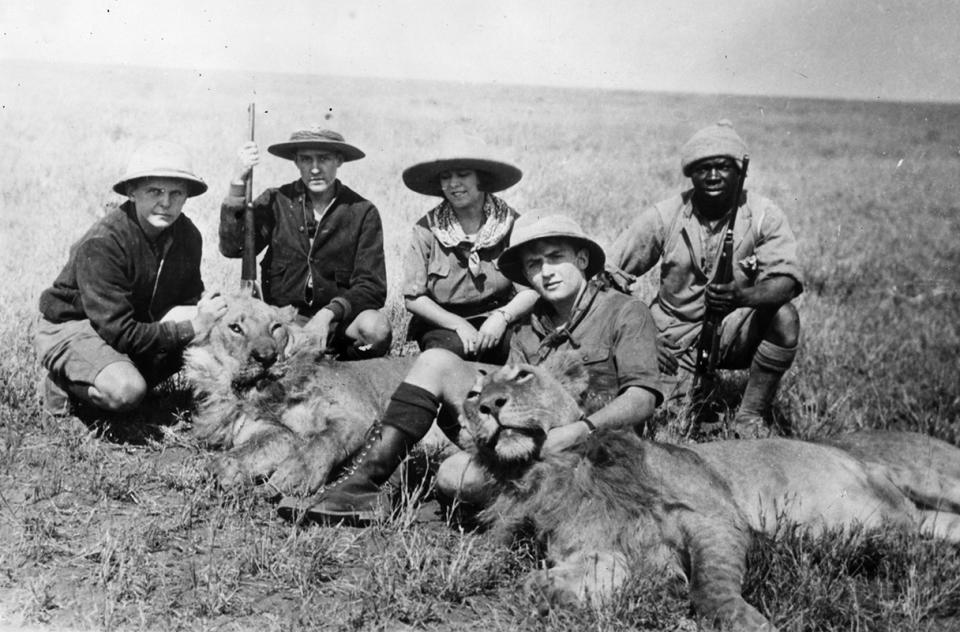 American anthropologist Osa Johnson and Jerramani, her African guide (right) pose with two dead lions in East Africa, in April 1930. With them are three Eagle Scouts who won a national Boy Scout competition to go on safari with the Johnsons in 1928, later writing the book 'Three Boy Scouts in Africa'. From left to right they are Robert Dick Douglas, Doug Oliver and David Martin. <cite>Topical Press Agency/Getty Images</cite>