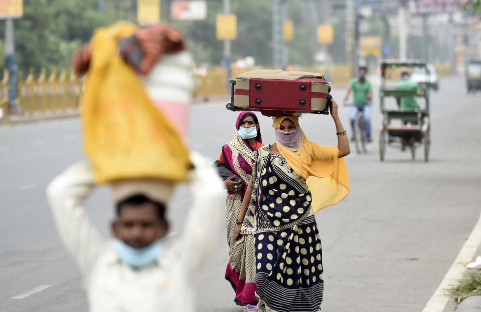 NEW DELHI, INDIA - MAY 13: Migrants leaving with luggage for their home states on foot during lockdown, near Anand Vihar, on May 13, 2020 in New Delhi, India. (Photo by Arvind Yadav/Hindustan Times via Getty Images)