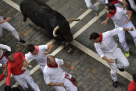 <p>Revellers run in front of Jandilla’s fighting bulls during the running of the bulls at the San Fermin Festival, in Pamplona, northern Spain, July 11, 2017. (AP Photo/Alvaro Barrientos) </p>