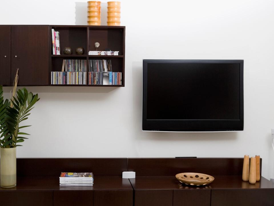 Shelves with CDs next to a TV