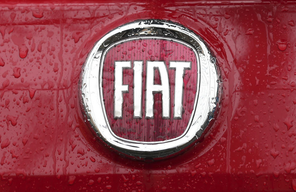 FILE - In this Jan. 2, 2014 file photo, a Fiat logo pictured on a car in Milan, Italy. Italian-American carmaker Fiat Chrysler Automobiles on Wednesday, Oct. 30, 2019 confirmed that it is in talks with French rival PSA Peugeot, its second bid this year to reshape the global auto industry facing huge challenges with the transition to electric and autonomous vehicles. (AP Photo/Antonio Calanni, File)