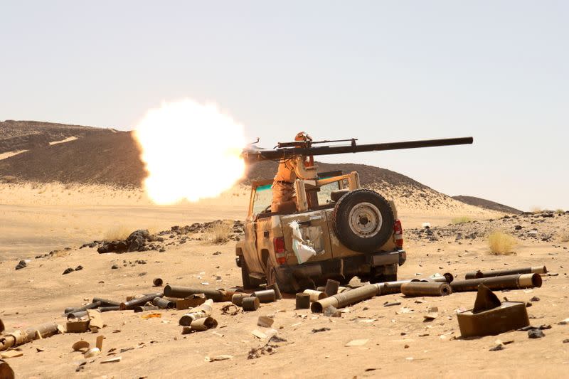 FILE PHOTO: Yemeni government fighter fires a vehicle-mounted weapon at a frontline position during fighting against Houthi fighters in Marib