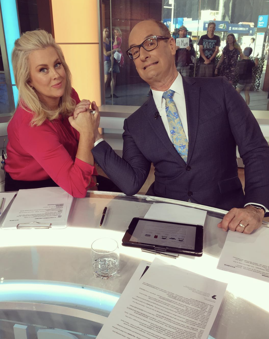 Samantha Armytage and her Sunrise co-host David Koch playfully arm wrestle on the Sunrise TV set