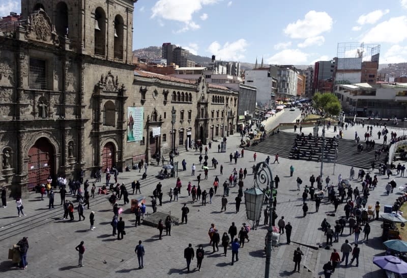 People walk at the Plaza San Francisco on the first day of eased coronavirus disease (COVID-19) restrictions in La Paz