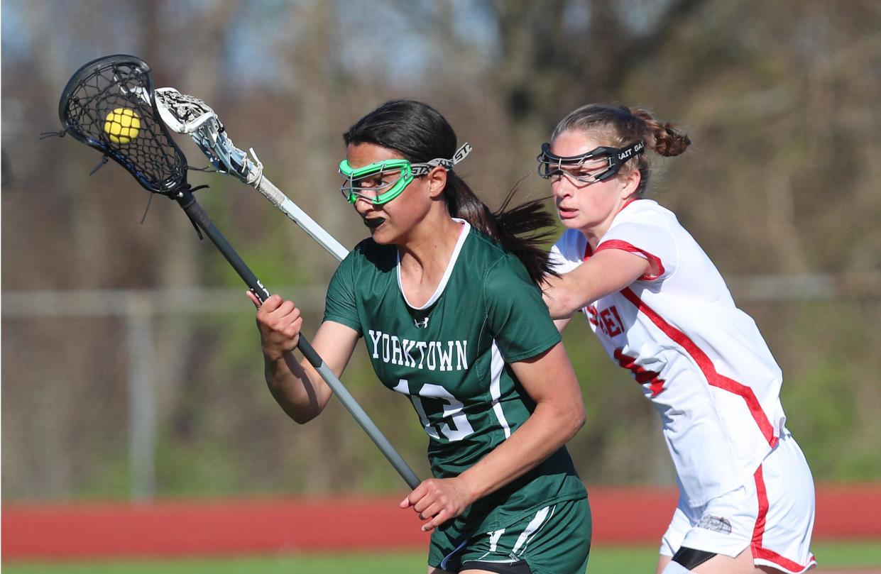 YorktownÕs Lily Diaz (13) drives to the goal in front of Somers Sydney Ingraham (4) during girls lacrosse action at Somers High School April 25, 2024. Yorktown won the game 8-5.