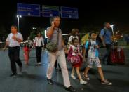 People leave Turkey's largest airport, Istanbul Ataturk, Turkey, following a blast June 28, 2016. REUTERS/Murad Sezer