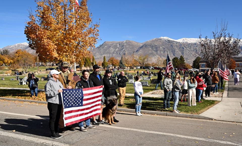 Community members line the road as the procession passes during a memorial service at American Fork city cemetery for U.S. Marine Corps Capt. Ralph Jim Chipman, who was lost during battle in Vietnam 50 years ago, on Saturday, Nov. 11, 2023. His remains were identified and returned to his family to be laid to rest. | Scott G Winterton, Deseret News