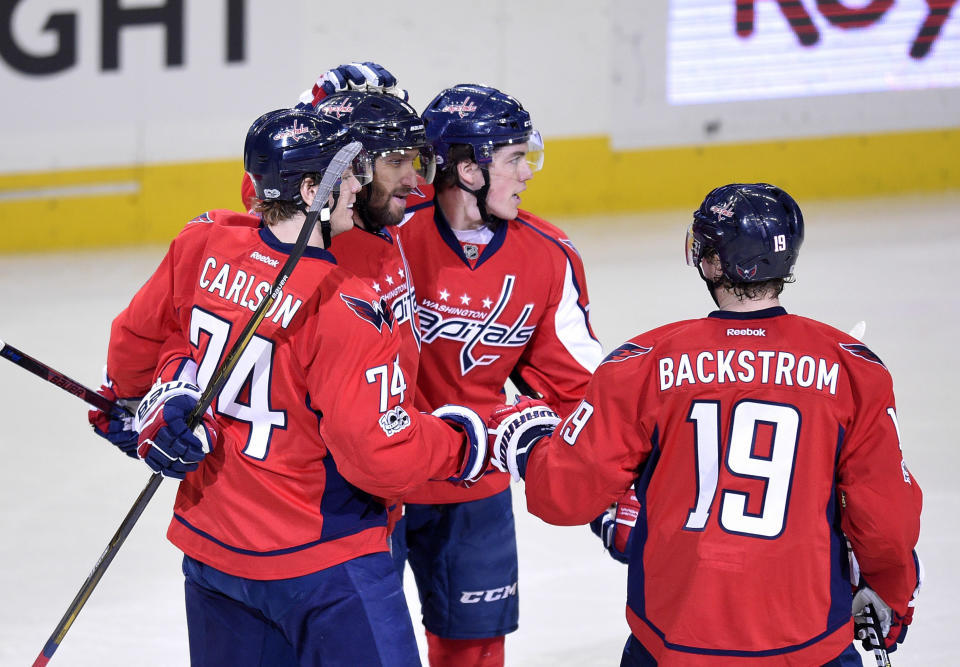 Washington Capitals left wing Alex Ovechkin, second from left, of Russia, celebrates his goal with defenseman John Carlson (74), center Nicklas Backstrom (19), of Sweden, and right wing T.J. Oshie, second from right, during the second period of an NHL hockey game against the Pittsburgh Penguins, Wednesday, Jan. 11, 2017, in Washington. (AP Photo/Nick Wass)