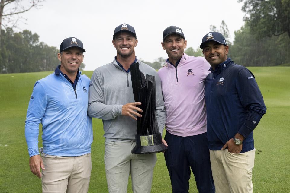 First place Team Champions, Paul Casey, Bryson Dechambeau, Charles Howell III and Anirban Lahiri of Crushers GC pose with the Event Team Champion Trophy after the final round of LIV Golf Hong Kong at the Hong Kong Golf Club in Hong Kong Sunday, March 10, 2024. (Montana Pritchard/LIV Golf via AP)