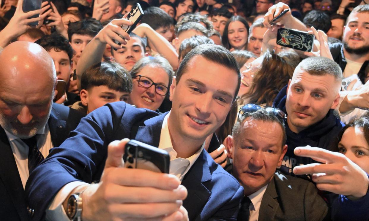 <span>Jordan Bardella poses for a selfie with supporters during a campaign rally for the upcoming European elections in Montbeliard, eastern France.</span><span>Photograph: Patrick Hertzog/AFP/Getty Images</span>