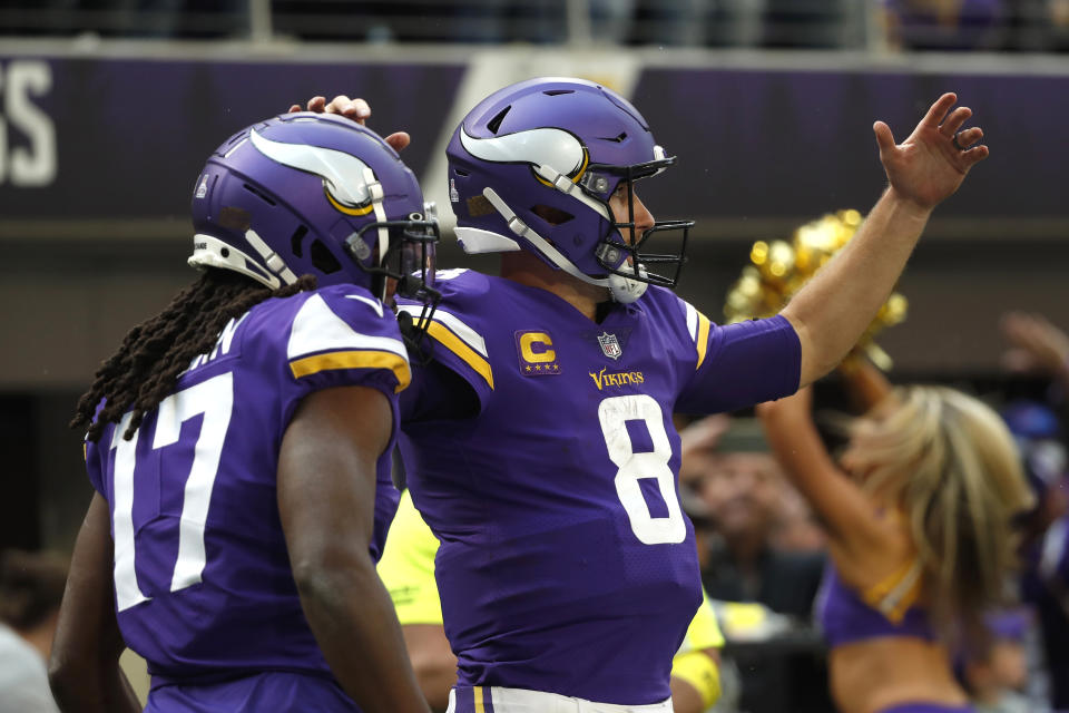 Minnesota Vikings quarterback Kirk Cousins (8) celebrates with teammate K.J. Osborn (17) after scoring on a 17-yard touchdown run during the first half of an NFL football game against the Arizona Cardinals, Sunday, Oct. 30, 2022, in Minneapolis. (AP Photo/Bruce Kluckhohn)