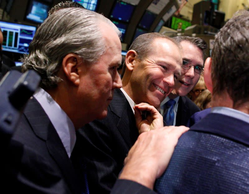 Nielsen CEO Calhoun is congratulated after his company's IPO opened on the floor of the New York Stock Exchange