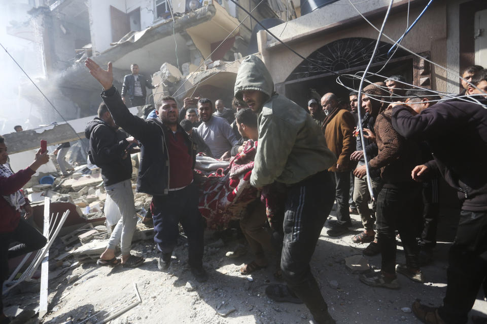 Palestinians rescue survivors after an Israelikm strike on Shaheen family house in Rafah, Gaza Strip, Saturday, Feb. 24, 2024. (AP Photo/Hatem Ali)