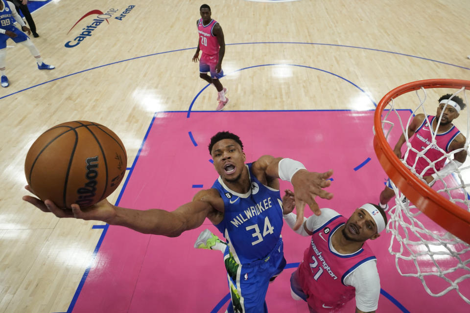 Milwaukee Bucks forward Giannis Antetokounmpo (34) goes up against Washington Wizards center Daniel Gafford (21) during the first half of an NBA basketball game, Tuesday, April 4, 2023, in Washington. (AP Photo/Jess Rapfogel)