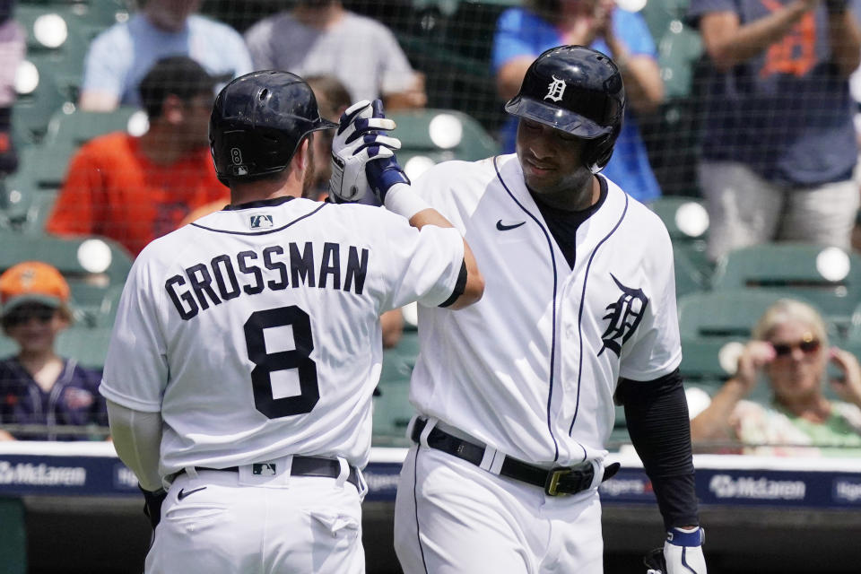 El jardinero derecho de los Tigres de Detroit, Robbie Grossman, recibe el saludo de Jonathan Schoop después de batear un jonrón en solitario en la primera entrada del primer juego de una doble jornada contra los Mellizos de Minnesota, sábado 17 de julio de 2021 en Detroit. Los T1gres ganaron 1-0. (AP Foto/Carlos Osorio)