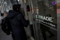 A man enters E*Trade Financial offices, after it was announced that Morgan Stanley is buying the discount brokerage, in New York