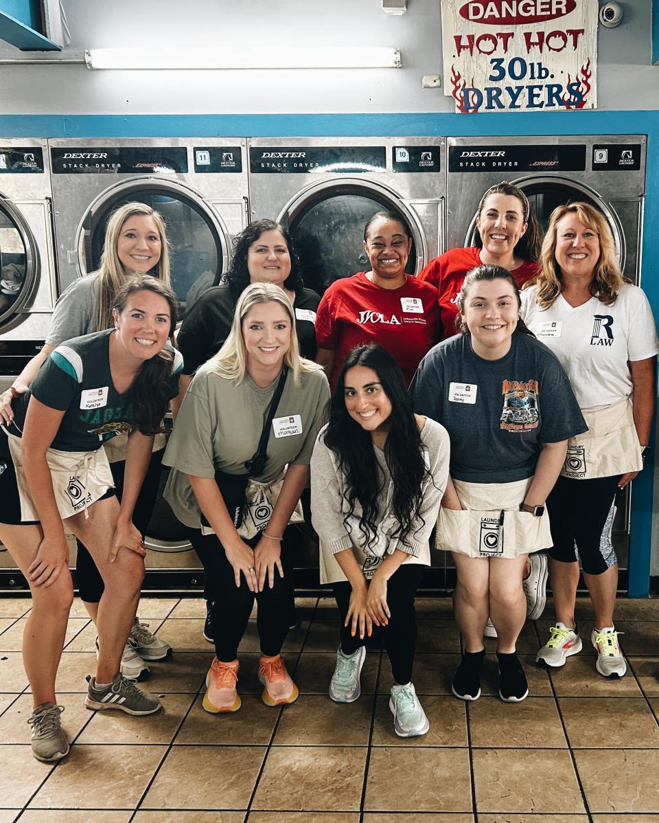 Jacksonville volunteers posed after washing closes for local laundromat customers, a recent event sponsored by the Laundry Project, a Tampa-based nonprofit.