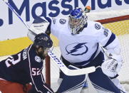 Tampa Bay Lightning goaltender Andrei Vasilevskiy (88) makes a save as Columbus Blue Jackets center Emil Bemstrom (52) skates near the net during the first period of Game 3 of an NHL hockey first-round playoff series, Saturday, Aug. 15, 2020, in Toronto. (Nathan Denette/The Canadian Press via AP)