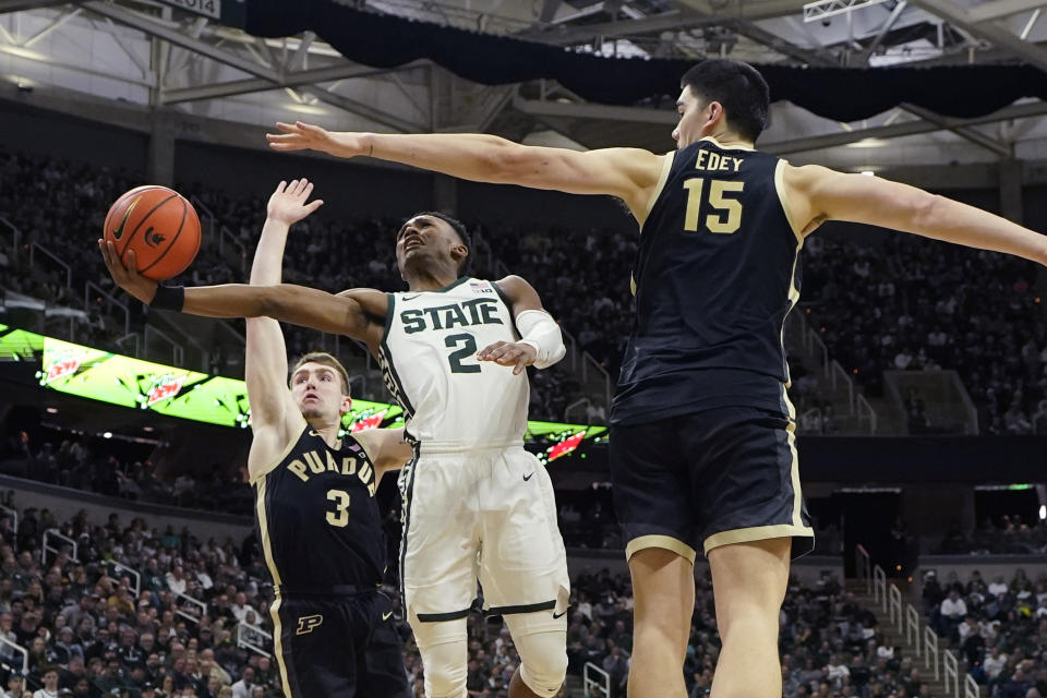 Michigan State guard Tyson Walker (2) attempts a layup as Purdue center Zach Edey (15) defends during the second half of an NCAA college basketball game, Monday, Jan. 16, 2023, in East Lansing, Mich. (AP Photo/Carlos Osorio)