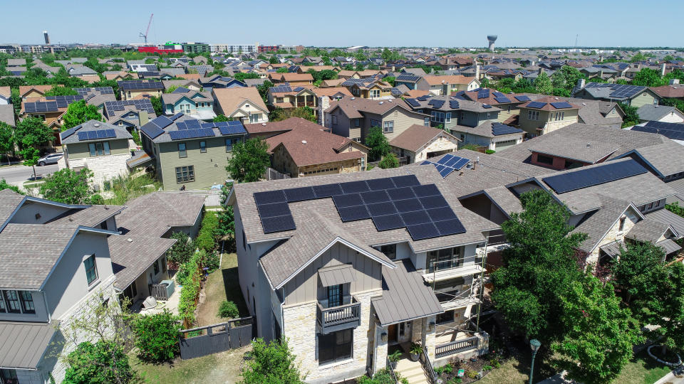 Housing development with multiple homes that have solar panels.