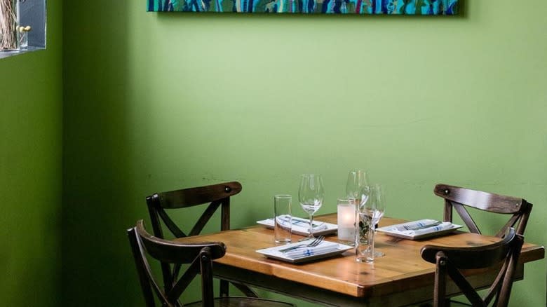 table in front of bright green wall