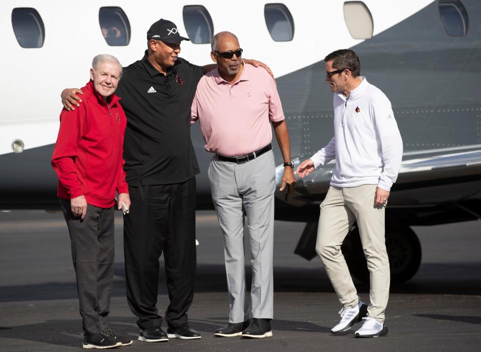 Kenny Payne arrived in Louisville, one day before he is expected to be announced as the new head basketball coach at the University of Louisville. Payne, center, stands for photo with embraces his former coach Denny Crum, left, and his former assistant coach Wade Houston, right. On far right, interim athletic director, Josh Heird Join the group. March 17, 2022