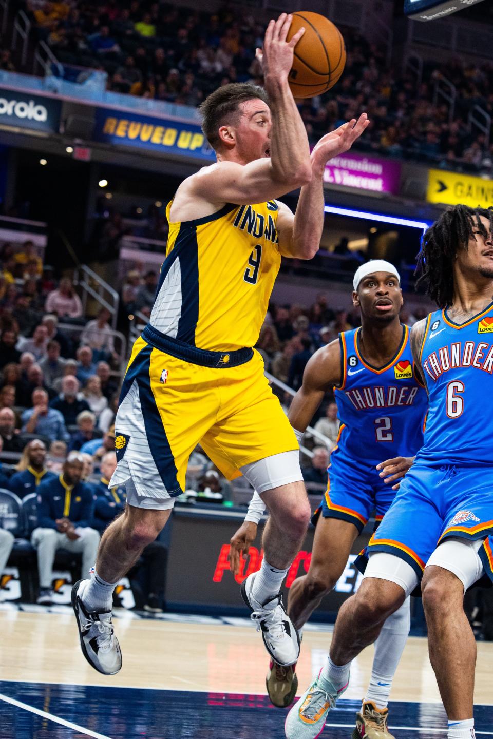 Mar 31, 2023; Indianapolis, Indiana, USA;  Indiana Pacers guard T.J. McConnell (9) passes the ball while Oklahoma City Thunder forward Jaylin Williams (6) defends in the second quarter at Gainbridge Fieldhouse. Mandatory Credit: Trevor Ruszkowski-USA TODAY Sports