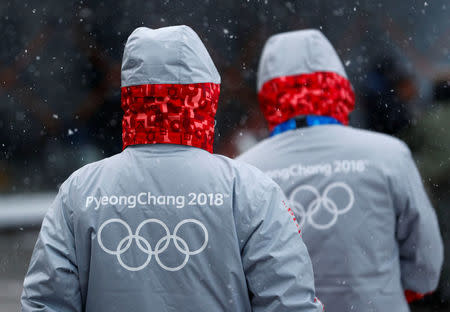 Volunteers for the upcoming 2018 Pyeongchang Winter Olympic Games walk in Pyeongchang, South Korea, January 22, 2018. REUTERS/Fabrizio Bensch
