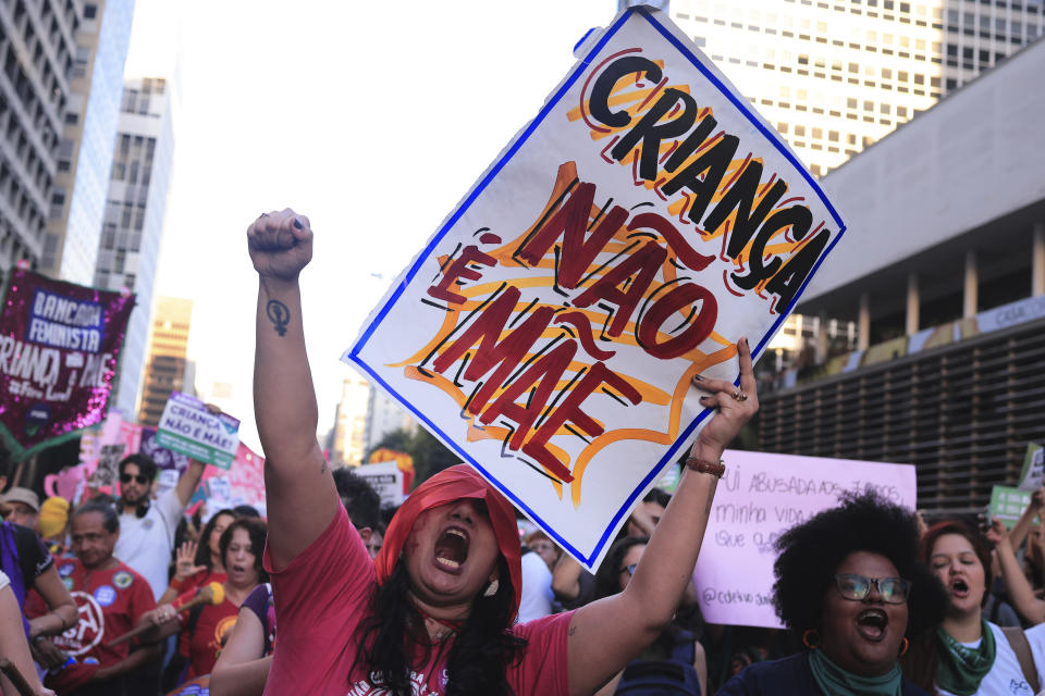 An abortion rights activist holds a sign with a message that reads in Portuguese, "A child is not a mother" during a march against an anti-abortion congressional bill, along Paulista Avenue in Sao Paulo, Saturday, June 15, 2024. (AP Photo/Ettore Chiereguini)