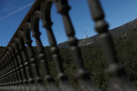The 150-metre-high cross of the Valle de los Caidos (Valley of the Fallen) monument where over 30,000 fighters from both sides of Spain's civil war are buried, is seen in San Lorenzo de El Escorial, outside Madrid, Spain, June 19, 2018. REUTERS/Susana Vera