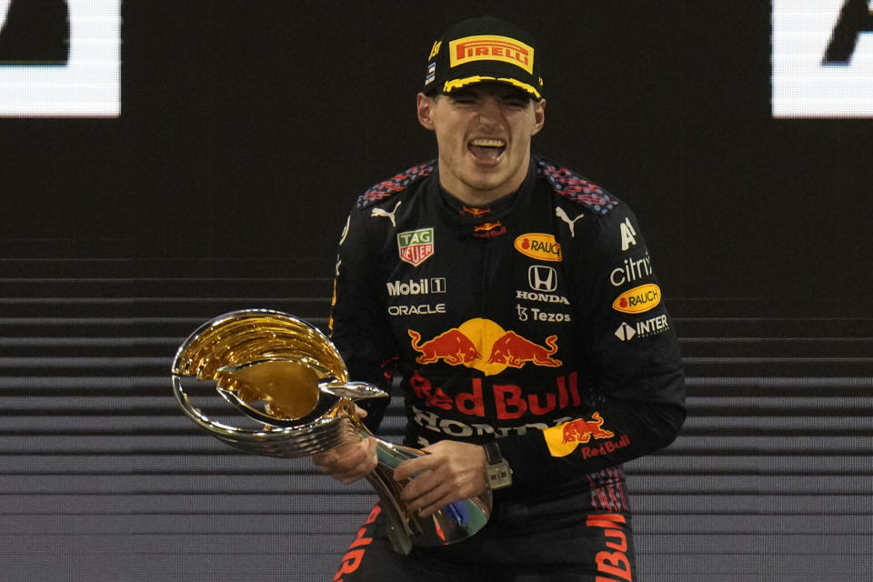 Red Bull driver Max Verstappen of the Netherlands celebrates after he became the world champion after winning the Formula One Abu Dhabi Grand Prix in Abu Dhabi, United Arab Emirates, Sunday, Dec. 12, 2021. (AP Photo/Hassan Ammar)