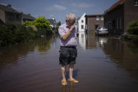 FILE - In this Saturday, July 17, 2021 file photo, Wiel de Bie, 75, stands outside his flooded home in the town of Brommelen, Netherlands. Scientists say there’s something different this year from the recent drumbeat of climate weirdness. This summer a lot of the places hit by weather disasters are not used to getting extremes and many of them are wealthier, which is different from the normal climate change victims. That includes unprecedented deadly flooding in Germany and Belgium, 116-degree heat records in Portland, Oregon and similar blistering temperatures in Canada, along with wildfires. Now Southern Europe is seeing scorching temperatures and out-of-control blazes too. And the summer of extremes is only getting started. Peak Atlantic hurricane and wildfire seasons in the United States are knocking at the door. (AP Photo/Bram Janssen, File)