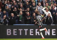 Newcastle United's Alexander Isak celebrates after scoring his side's third goal during the English Premier League soccer match between Newcastle United and Tottenham Hotspur at St. James' Park in Newcastle, England, Saturday, April 13, 2024. (Owen Humphreys/PA via AP)