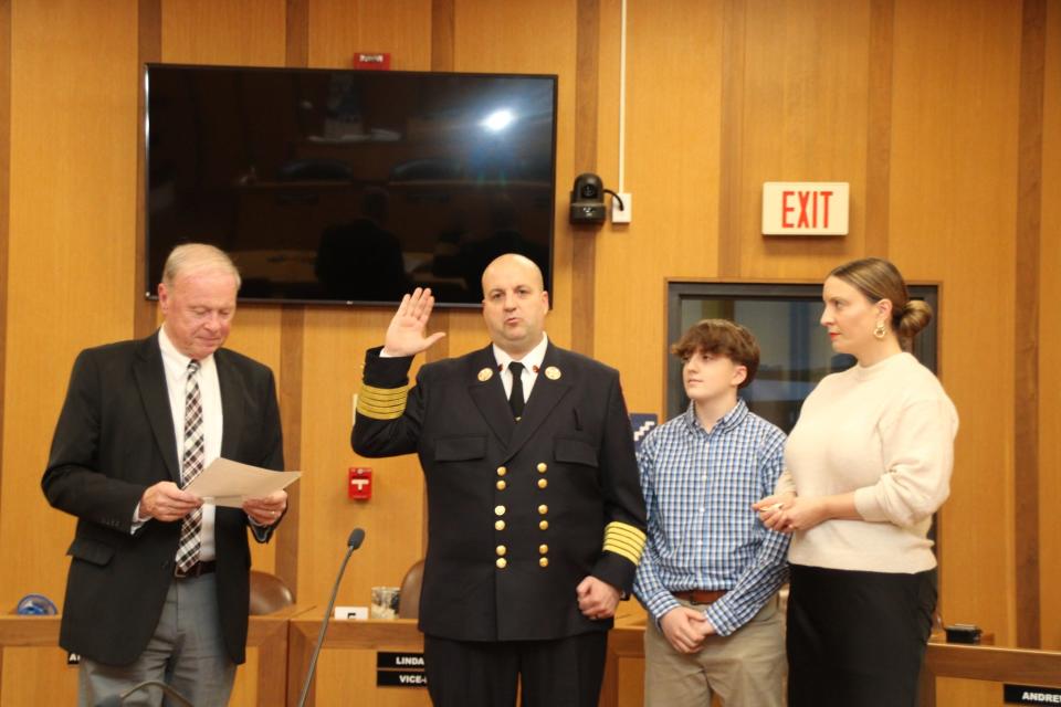 Mayor Paul Coogan swears in Fall River Fire Chief Jeffrey Bacon with his family.