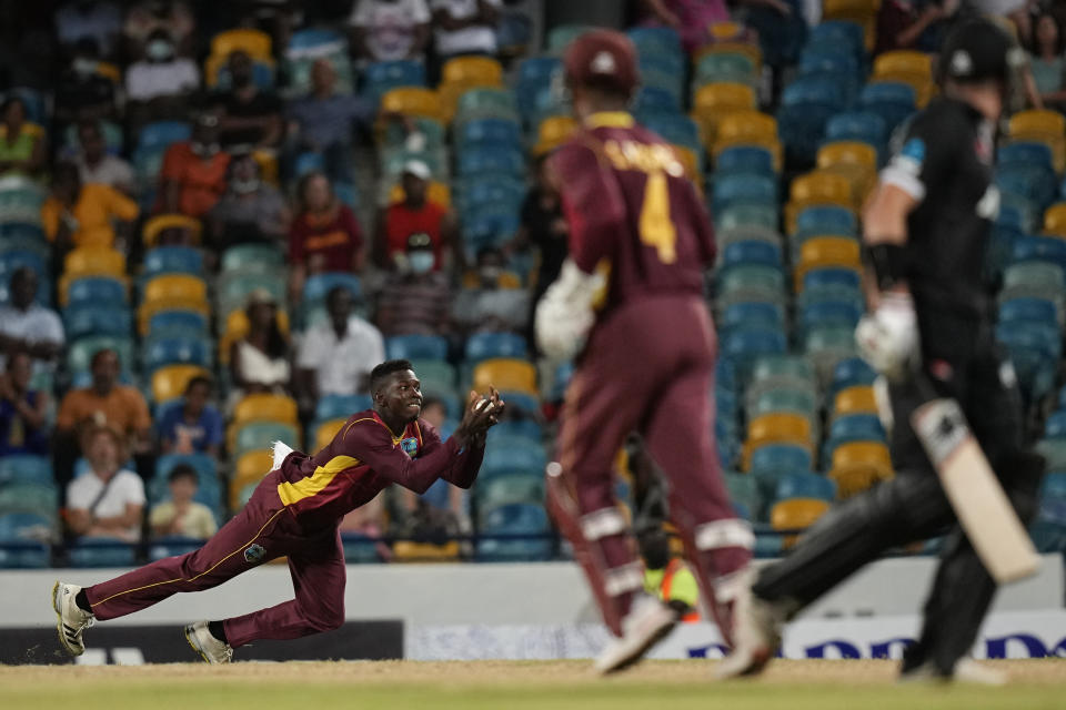 West Indies' Kevin Sinclair takes the catch from his own bowling to dismiss New Zealand's Trent Boult during the second ODI at Kensington Oval in Bridgetown, Barbados, Friday, Aug. 19, 2022. (AP Photo/Ramon Espinosa)