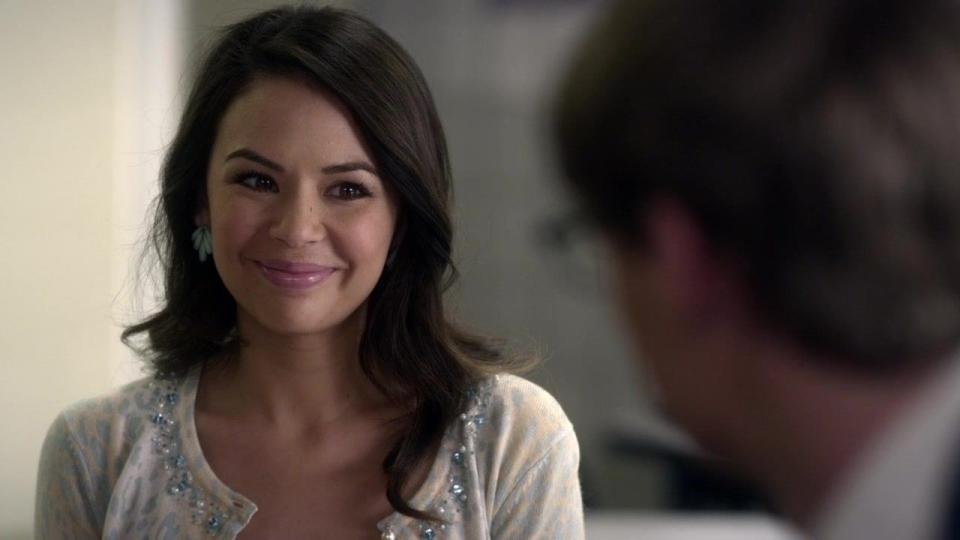 A still from PLL - Mona smiles sweetly at a man we can't see