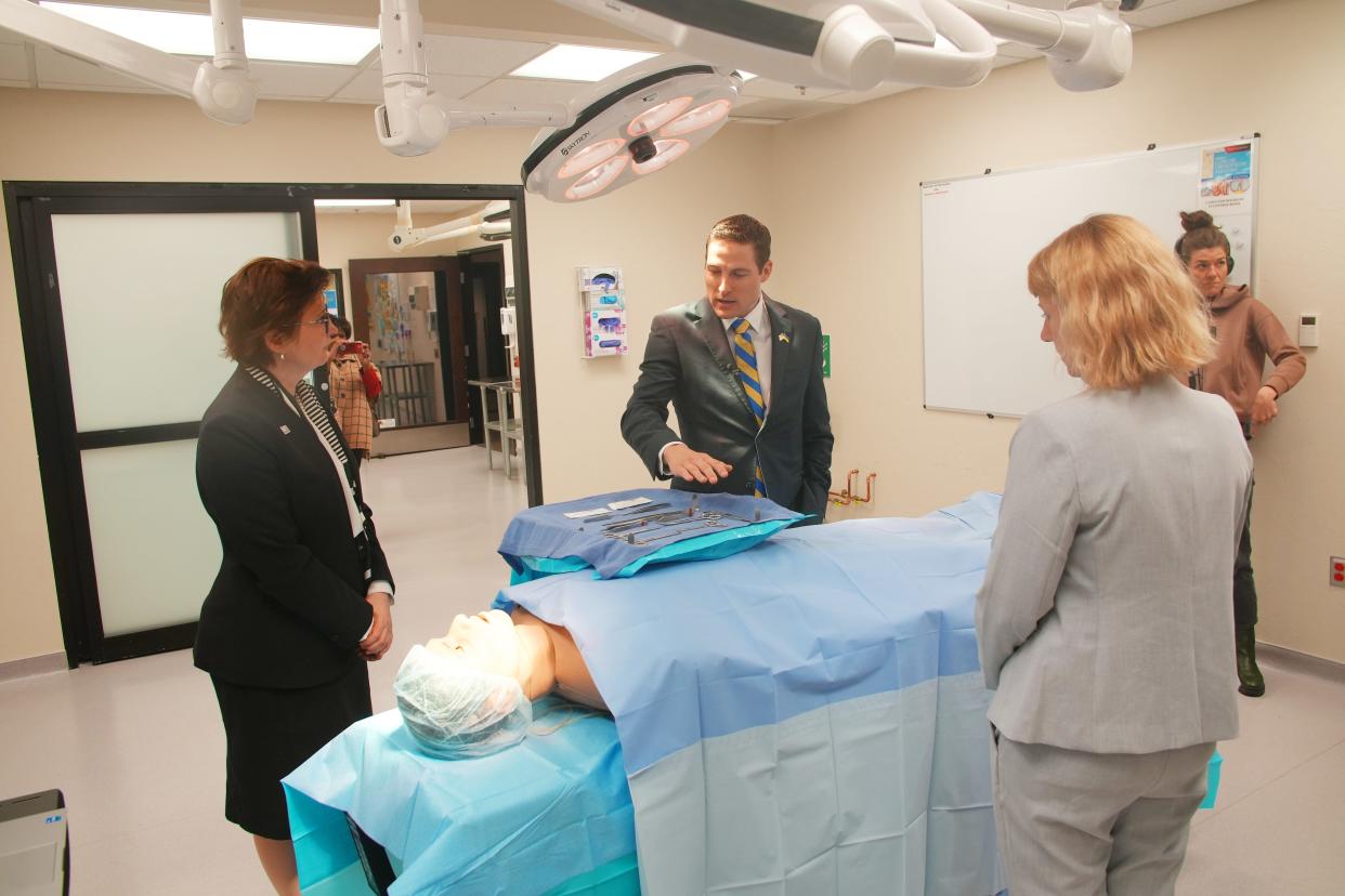 Kateryna Smagliy, Mark Mims, M.D., and Heather A. Conley discuss Operation Ukraine during a tour of a lab on Tuesday at the University of Oklahoma Health Sciences Center.