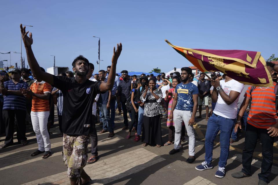 Protesters dance shouting slogans against president Gotabaya Rajapaksa outside his office in Colombo, Sri Lanka, Wednesday, July 13, 2022. The president of Sri Lanka fled the country early Wednesday, slipping away in the middle of the night only hours before he was to step down amid a devastating economic crisis that has triggered severe shortages of food and fuel. (AP Photo/Eranga Jayawardena)