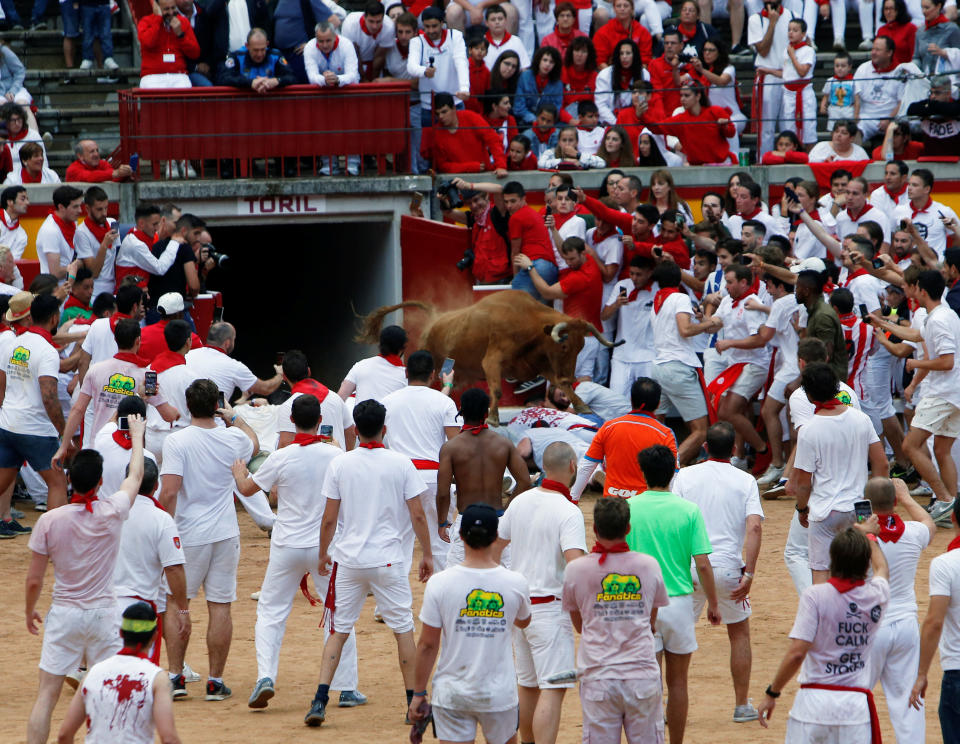 A wild cow leaps over revellers following the first running of the bulls at the San Fermin festival in Pamplona, Spain, July 7, 2018 (REUTERS)