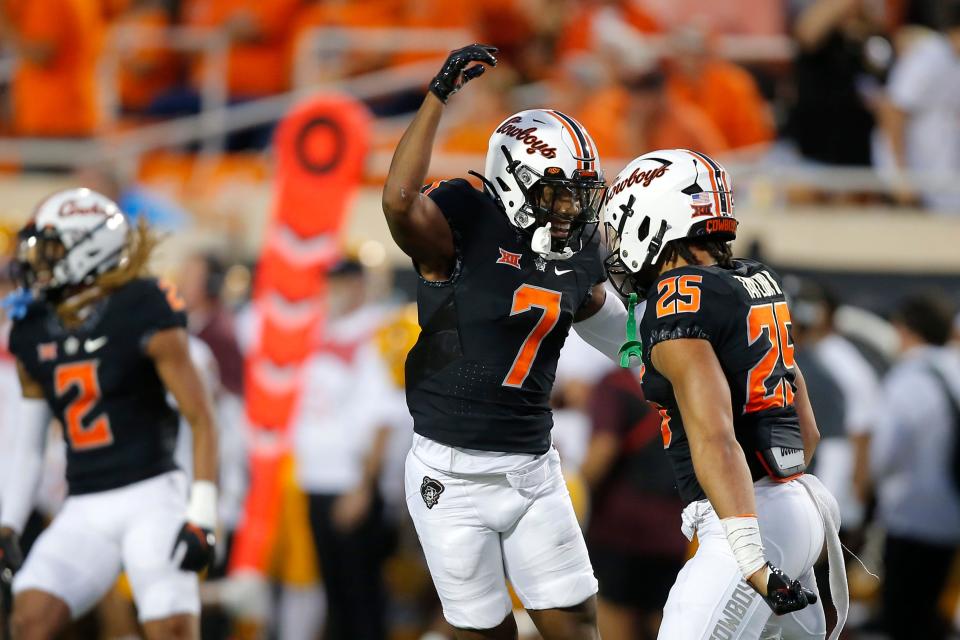 Oklahoma State cornerback Jabbar Muhammad (7) and safety Jason Taylor II (25) celebrate during a 34-17 win against Arizona State on Sept. 10 in Stillwater.