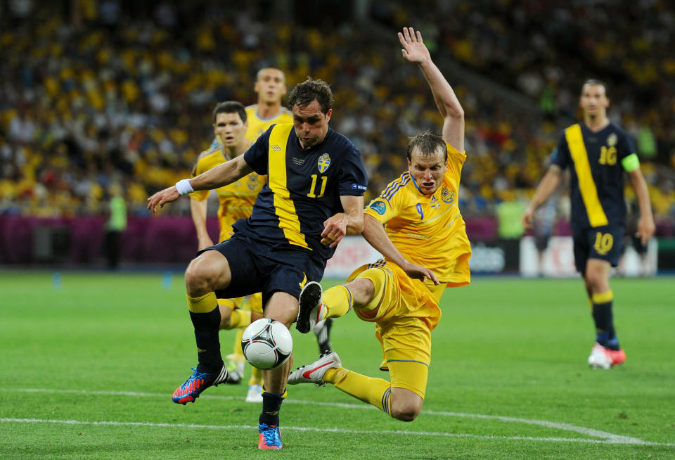 KIEV, UKRAINE - JUNE 11: Johan Elmander of Sweden and Oleh Husyev of Ukraine compete for the ball during the UEFA EURO 2012 group D match between Ukraine and Sweden at The Olympic Stadium on June 11, 2012 in Kiev, Ukraine. (Photo by Laurence Griffiths/Getty Images)