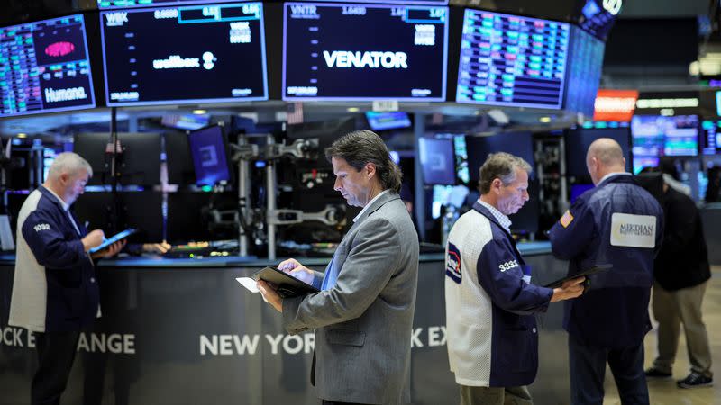 Traders work on the floor of the NYSE in New York