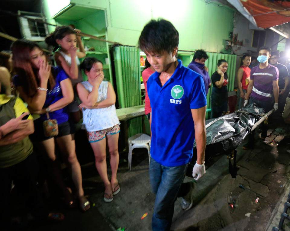 <p>Filipino residents view a dead body of an alleged drug dealer killed during a police operation against illegal drugs in Manila, Philippines, Aug. 23, 2016. The Senate has started its investigation into the alleged extrajudicial killings of suspected criminals under the current administration. According to Police data which was submitted to by Philippine National Police Director General Ronald dela Rosa on Aug. 22, at least 712 people were slain during anti-drug police operations, and 1,067 more deaths committed by still unidentified killers, based on a tally from July 1 to Aug. 21. (Eugenio Loreto/EPA) </p>