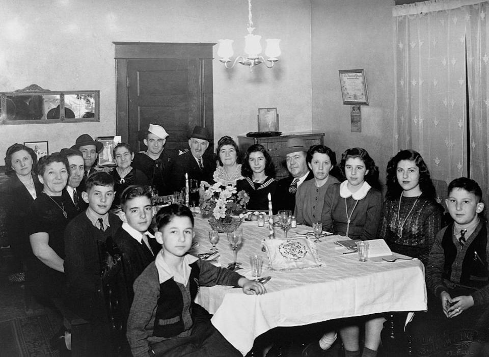 A Jewish family welcomes home a man in the Navy during a Passover Seder at their home in St. Paul, Minn., in 1943. <a href="https://www.gettyimages.com/detail/news-photo/jewish-family-welcomes-home-their-navy-man-and-gathers-for-news-photo/576825922?adppopup=true" rel="nofollow noopener" target="_blank" data-ylk="slk:Minnesota Historical Society/Corbis Historical via Getty Images;elm:context_link;itc:0;sec:content-canvas" class="link ">Minnesota Historical Society/Corbis Historical via Getty Images</a>