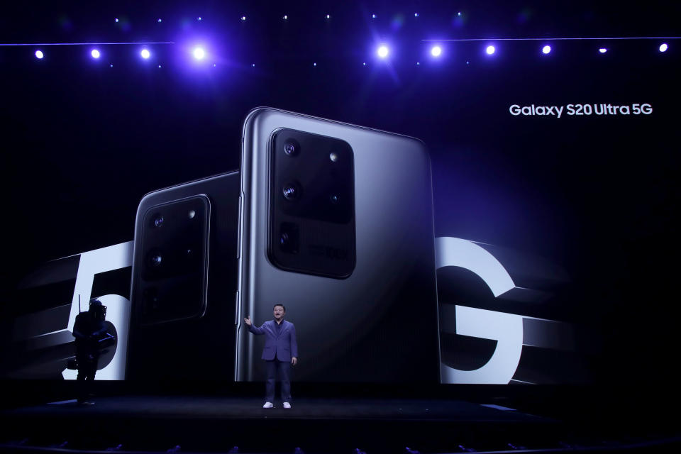 TM Roh, President and Head of Mobile Communications Business, speaks in front of a photo of Samsung Galaxy S20 Ultra 5G phones while speaking at the Unpacked 2020 event in San Francisco, Tuesday, Feb. 11, 2020. (AP Photo/Jeff Chiu)