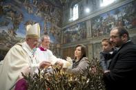 Pope Francis baptises one of 32 babies during a mass in the Sistine Chapel at the Vatican January 12, 2014, in this handout courtesy of Osservatore Romano. REUTERS/Osservatore Romano/Handout via Reuters (VATICAN - Tags: RELIGION) ATTENTION EDITORS - THIS IMAGE WAS PROVIDED BY A THIRD PARTY. FOR EDITORIAL USE ONLY. NOT FOR SALE FOR MARKETING OR ADVERTISING. THIS PICTURE IS DISTRIBUTED EXACTLY AS RECEIVED BY REUTERS, AS A SERVICE TO CLIENTS. NO SALES. NO ARCHIVES