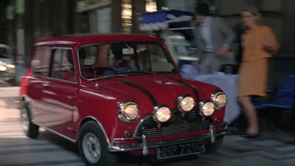 Several Mini Coopers drive through the streets of Italy in The Italian Job