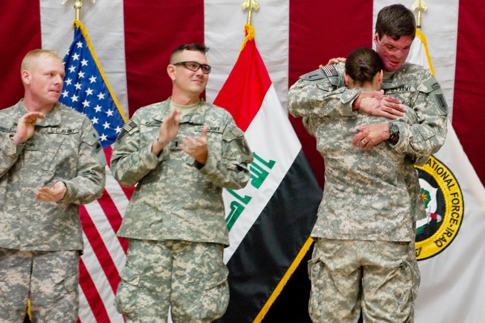 Capt. Sam Brown hugs his wife, Capt. Amy Brown, after arriving in Baghdad to take part in Operation Proper Exit.  (U.S. Army)